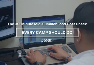 Food service director reviewing inventory and food cost in a summer camp kitchen during a mid-season operational review.